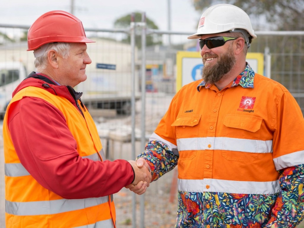 Construction builder shaking hands with Red Insight WHS consultant James Brown on a worksite