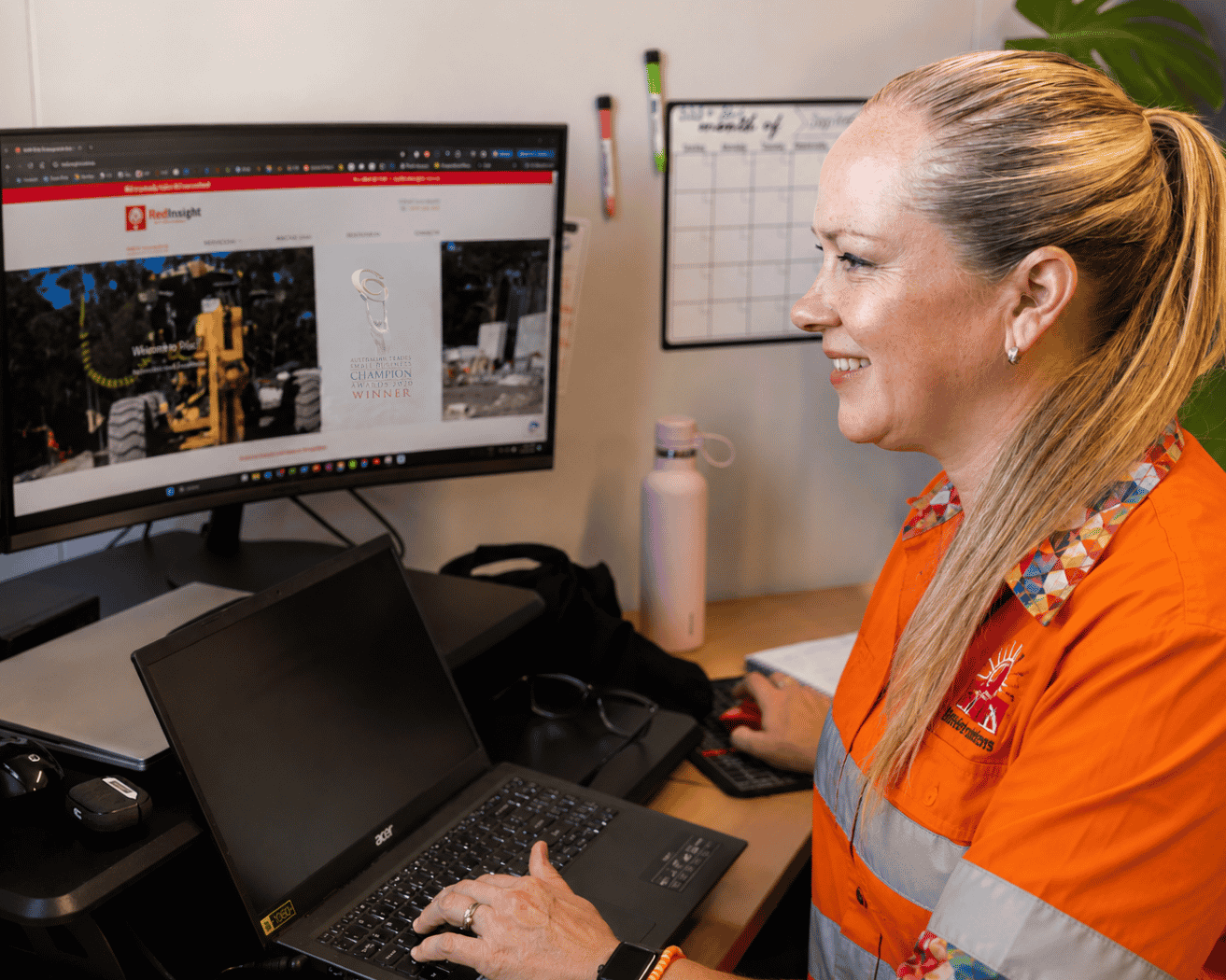 AI-edited image of Monica Toews Brown, Director of Red Insight, working at her desk to illustrate the importance of professional judgement when using artificial intelligence in workplace health and safety.